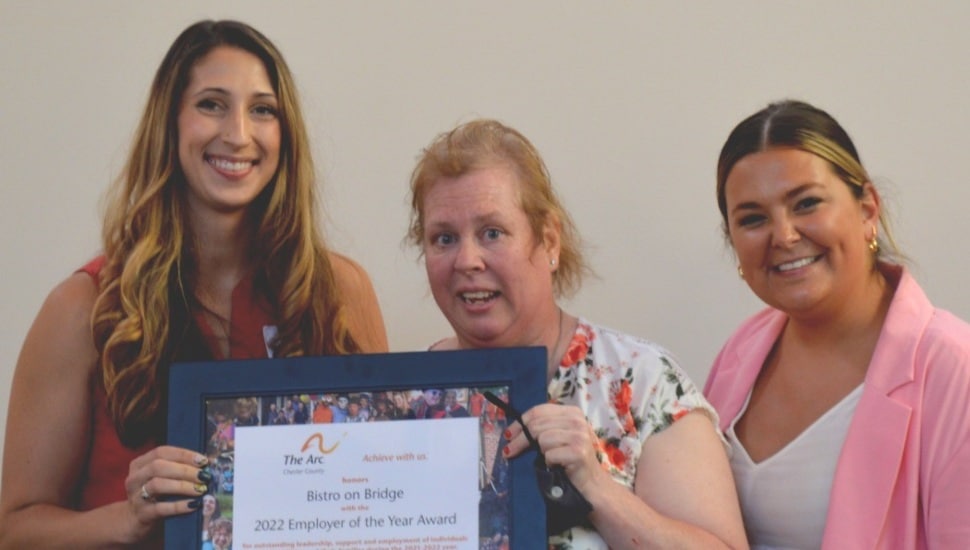 Bistro on Bridge staff hold the Arc of Chester County's Employee of the Year Award, presented by Arc's director of Employment Services Shelby Hallman