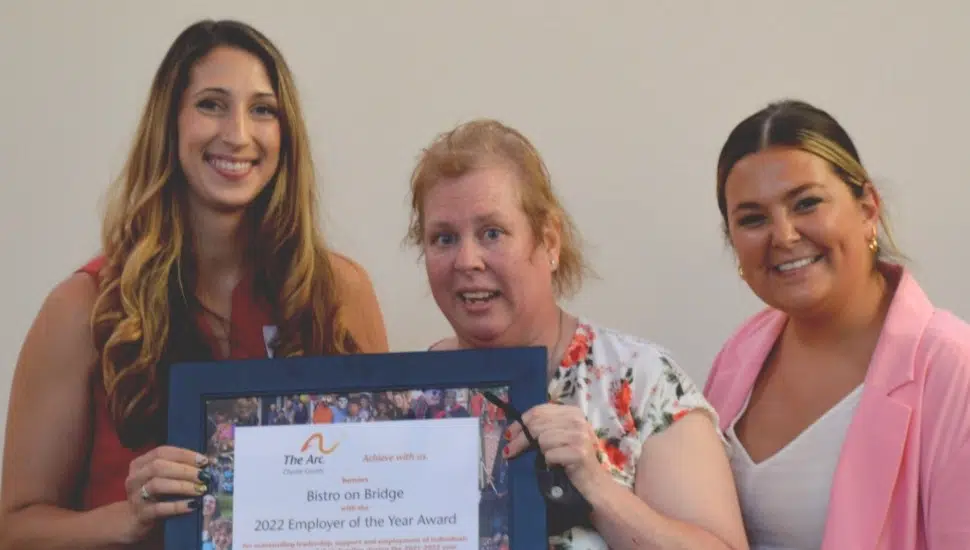 Bistro on Bridge staff hold the Arc of Chester County's Employee of the Year Award, presented by Arc's director of Employment Services Shelby Hallman