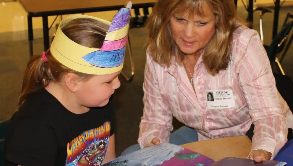 woman reading to a little girl