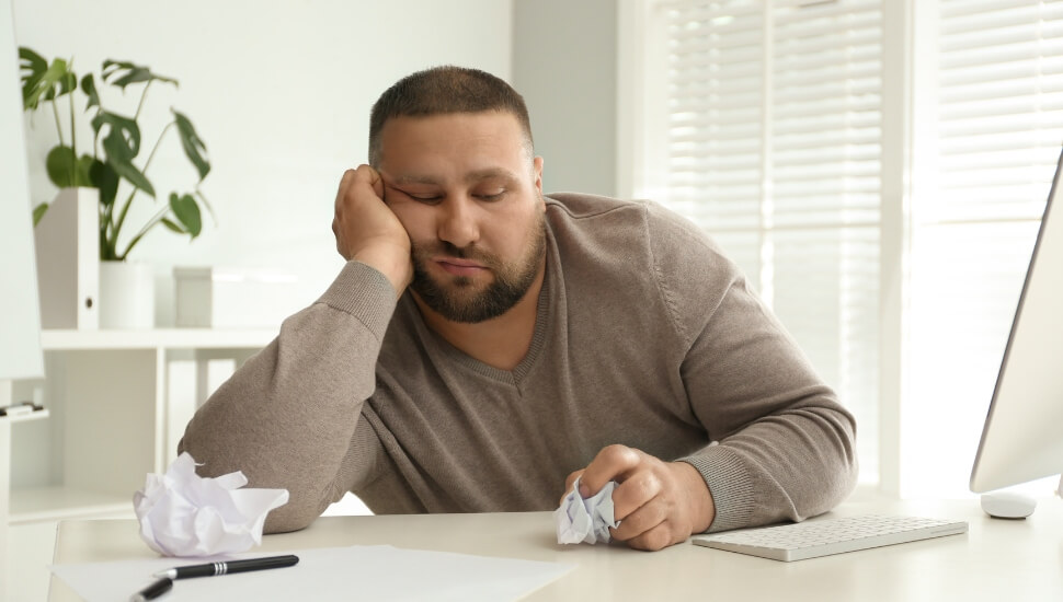Overweight man at his desk