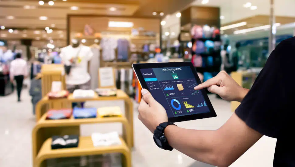 Retail store manager checking store stats on an ipad