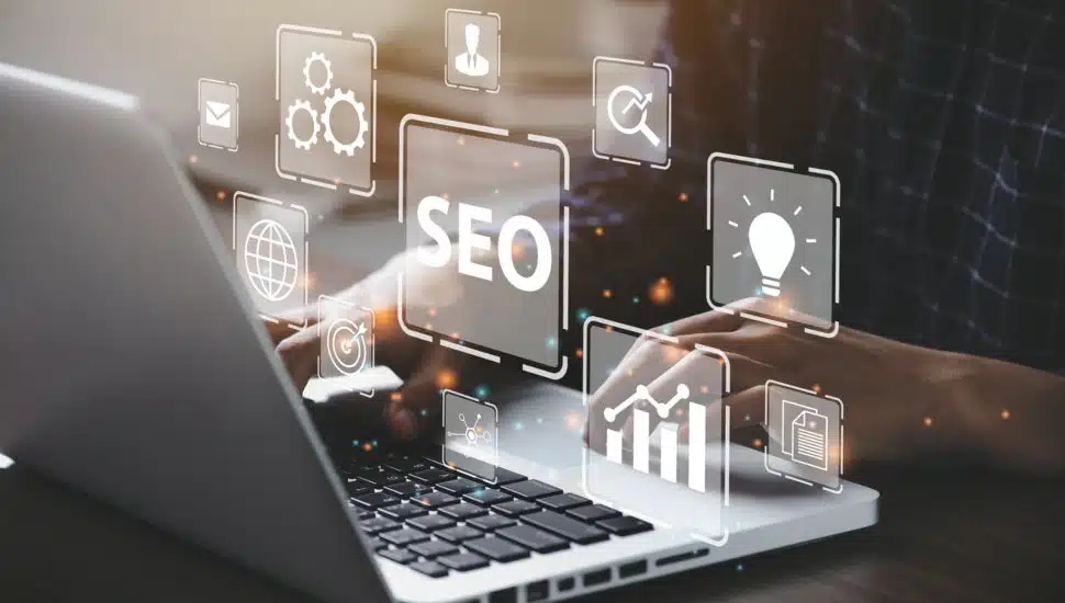 person searching on laptop for SEO services