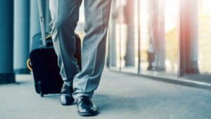 businessman traveling dragging suitcase