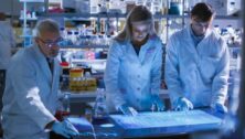 three people working on pharmaceutical manufacturing