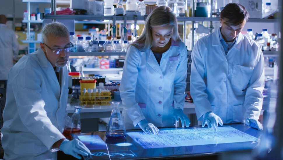 three people working on pharmaceutical manufacturing