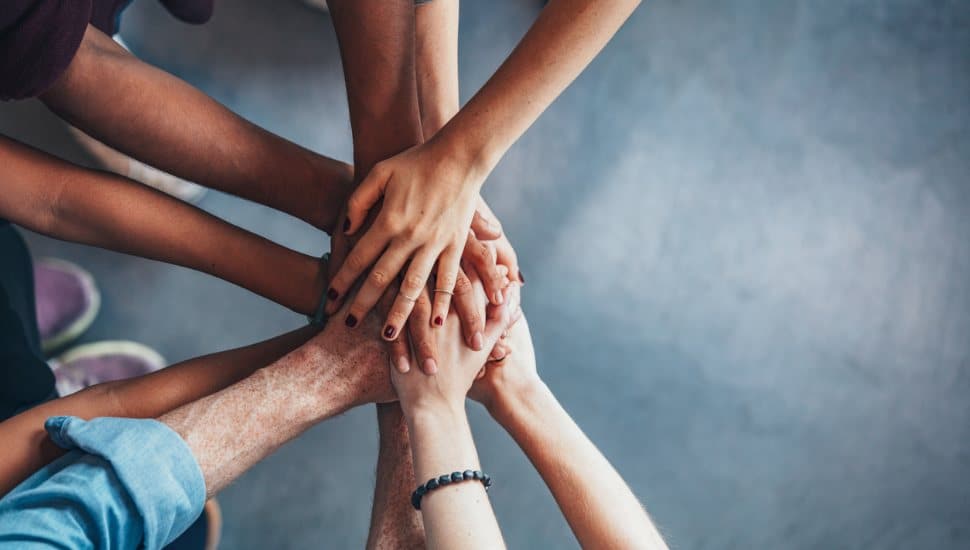 group of women crossing hands