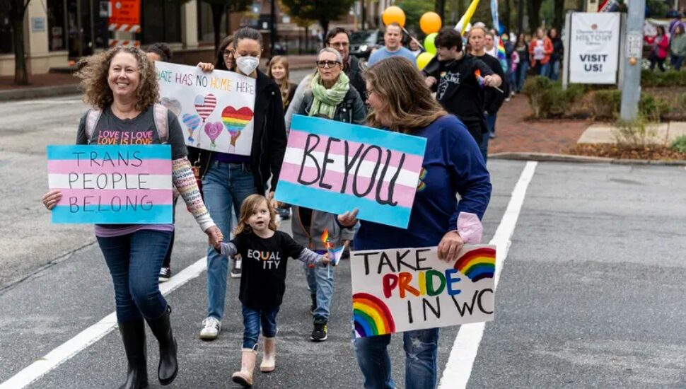 people holding LGBTQ support signs