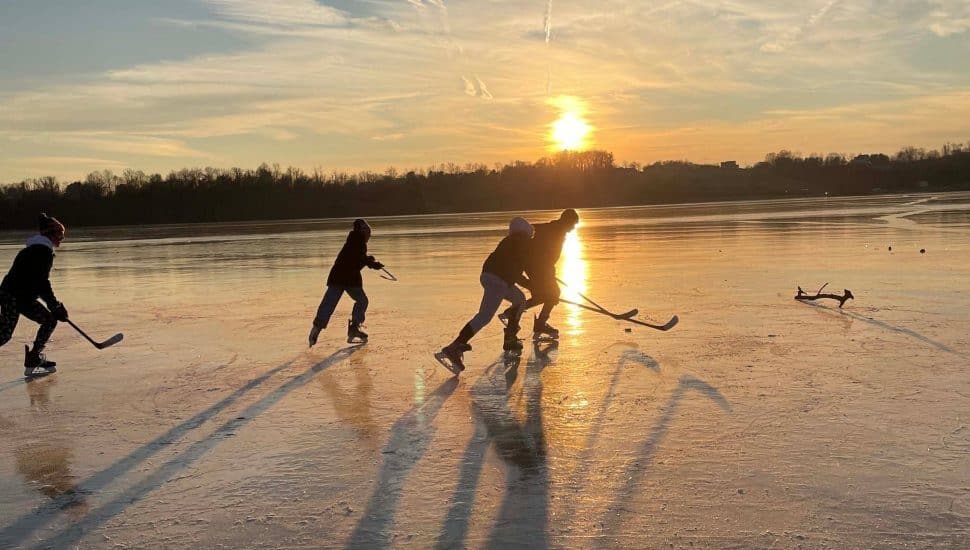 people playing hockey on ice in winter