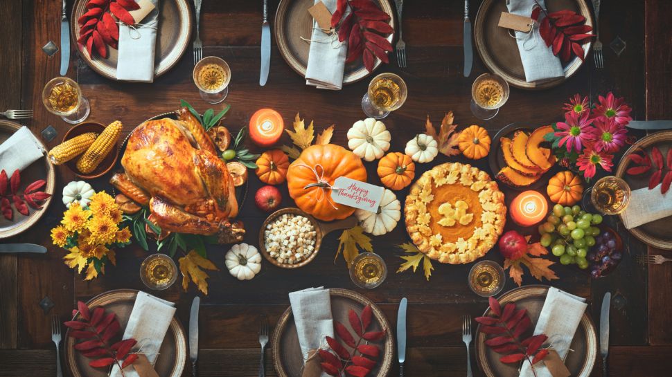 A decorated table with Thanksgiving food