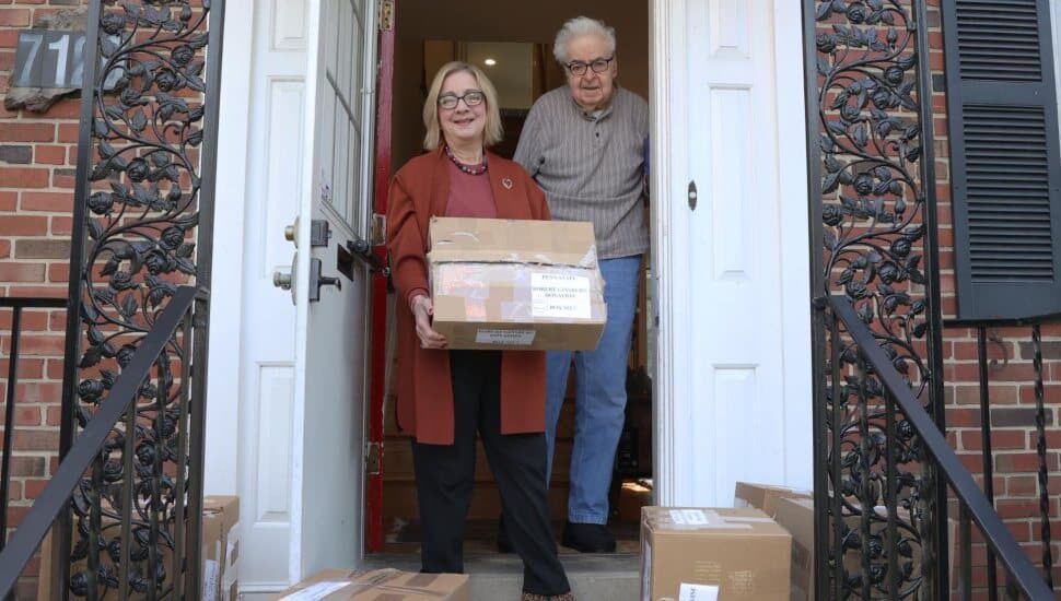 Penn State Brandywine Chancellor Marilyn J. Wells picked up boxes of academic and historic documents from the home of the university's first professor, Robert Ginsberg