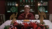 boy at table wearing Christmas sweater