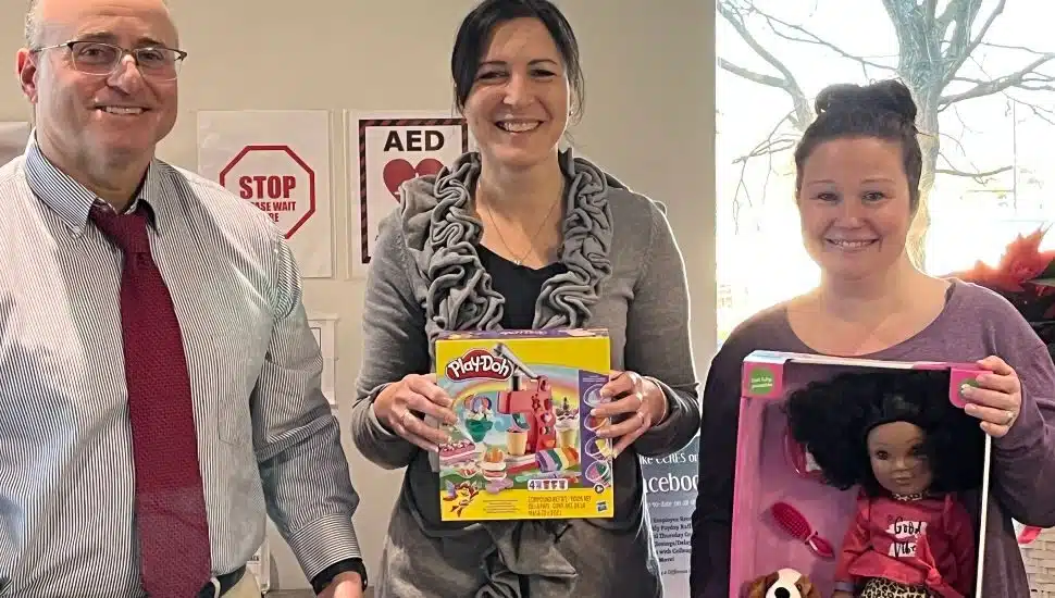 Volunteers participated in the Andrew L. Hicks Jr. Foundation 13th annual Christmas Spectacular toy drive. They are (from left) Joe Vaillancourt, Kara Davison, and Alyssa McKenzie