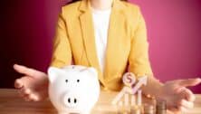 Businesswoman with rows of coins with graph for finance and business concept. coins with piggy bank. S