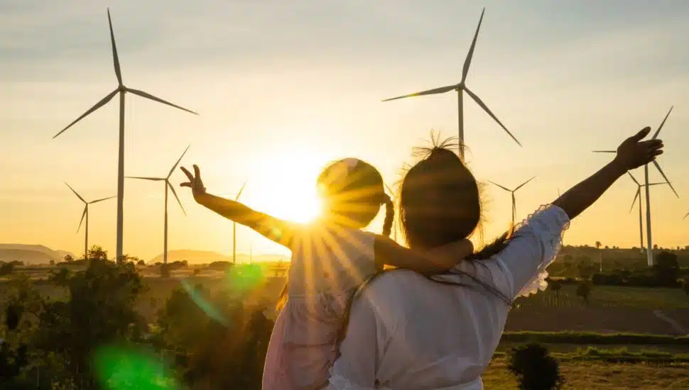 Wind turbines are alternative electricity sources, the concept of sustainable resources, People in the community with wind generators turbines, Renewable energy.