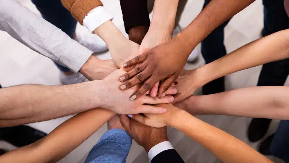 group of people stacking hands