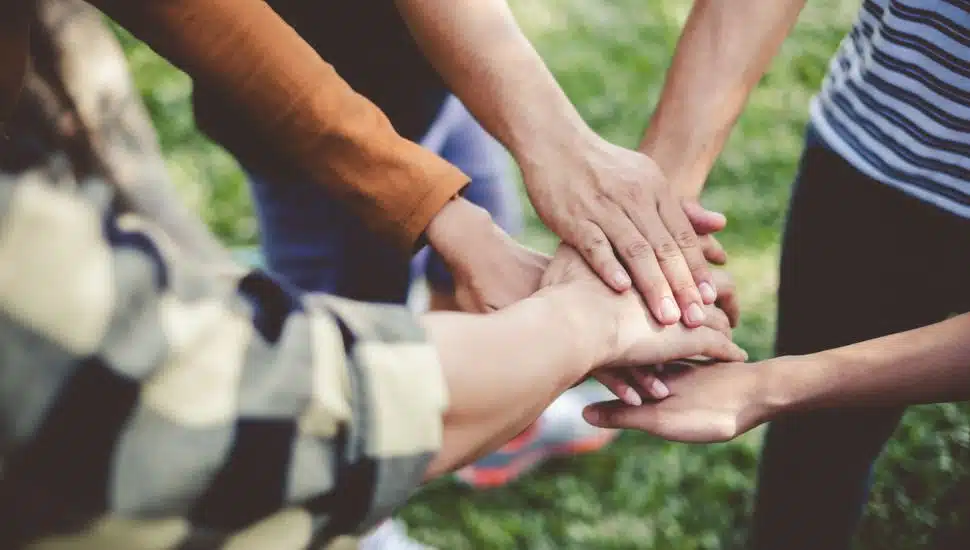 group of people stacking hands