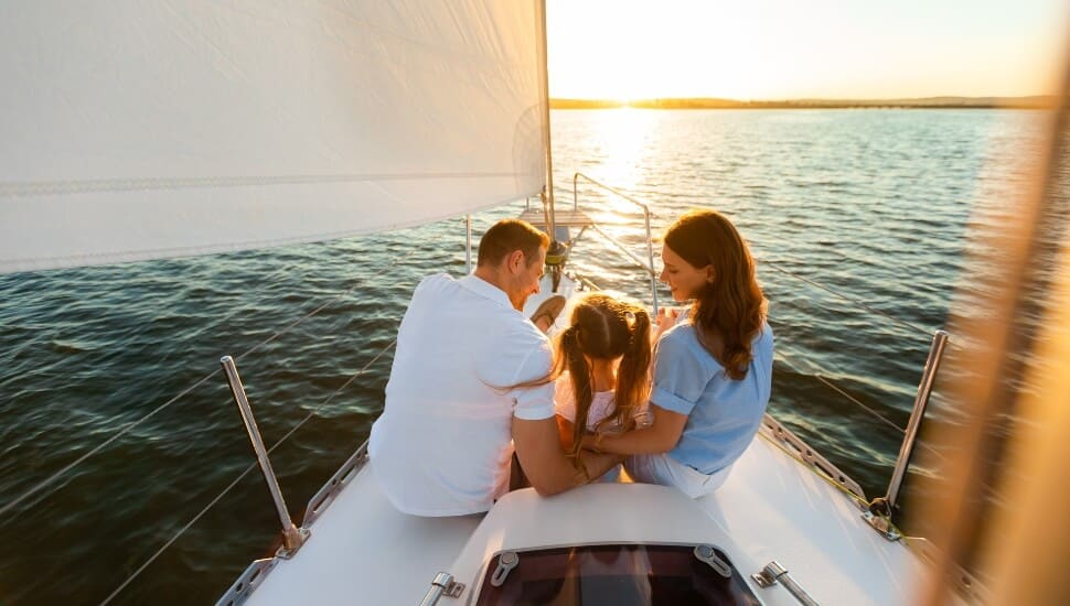 Couple on a sail boat with their young daughter