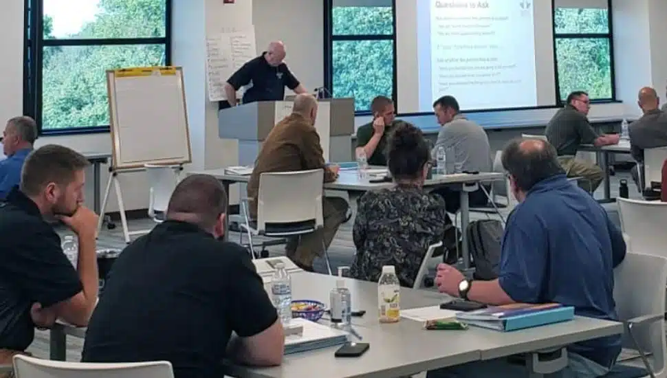 people sitting at desks in a room