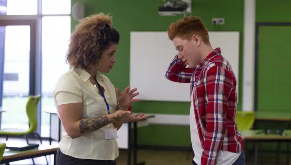 A woman counselor talking with a male student
