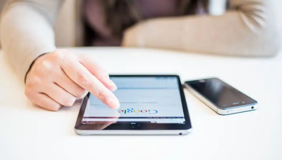 woman typing in Google on phone