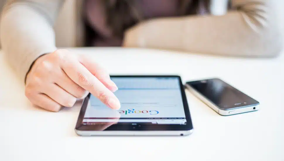 woman typing in Google on phone