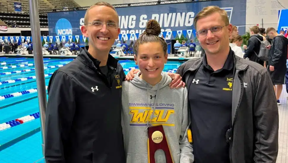 Ann Carozza, center, coach Steve Mazurek, left, and assistant coach Victor Polyakov.