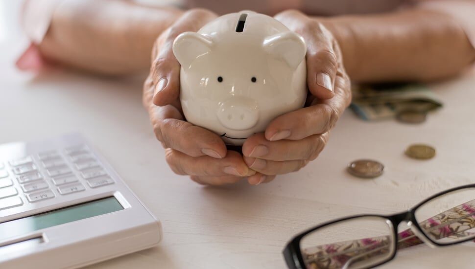 Young woman holding piggy bank