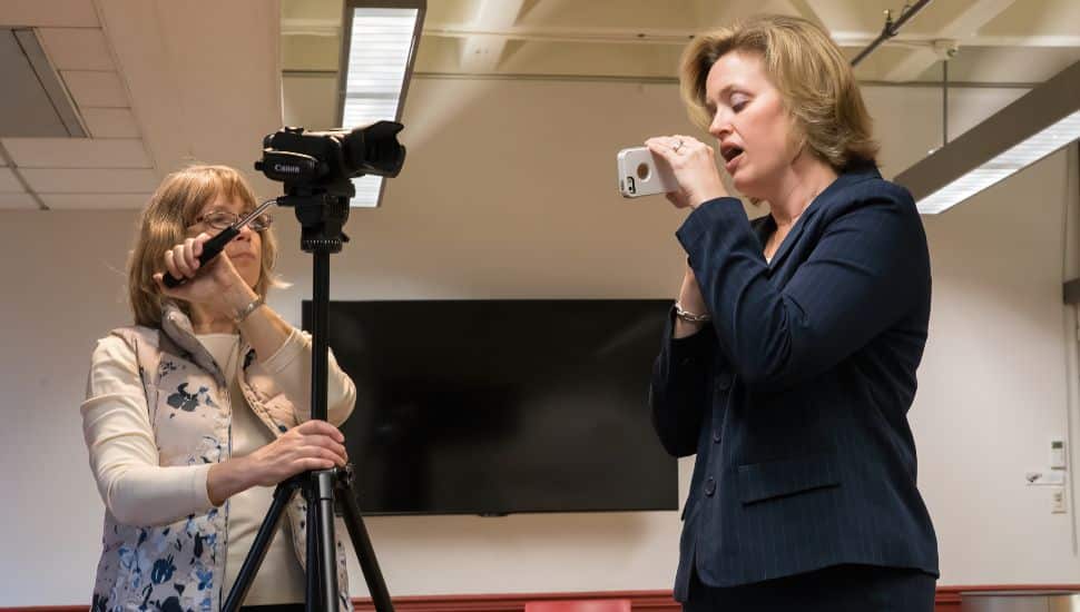 West Chester University Professor of Communication Sciences and Disorders Liz Grillo, right, shows 6ABC Action News HealthCheck Producer Dawn Heefner how to use the VoiceEvalU8 tool that Professor Grillo invented to help today’s teachers reduce debilitating voice disorders.
