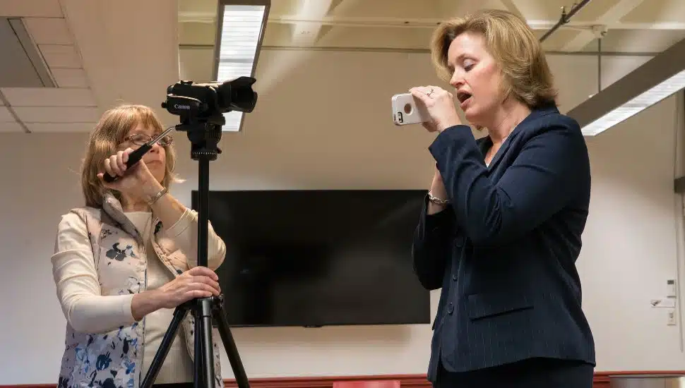 West Chester University Professor of Communication Sciences and Disorders Liz Grillo, right, shows 6ABC Action News HealthCheck Producer Dawn Heefner how to use the VoiceEvalU8 tool that Professor Grillo invented to help today’s teachers reduce debilitating voice disorders.