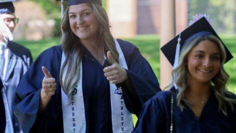 Farrell Everett expresses her excitement as she and classmate Brooke Buchakjian process to Brandywine's gymnasium for the campus' spring commencement ceremony on May 6.