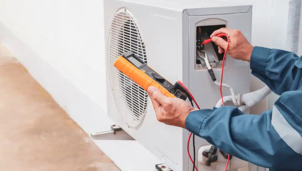 Air conditioner technician checking air conditioner operation