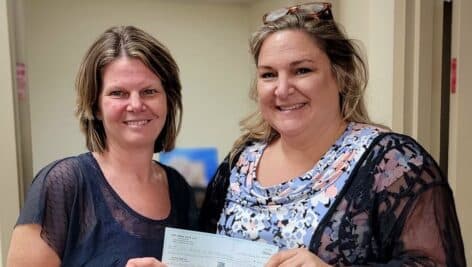 Jessica Minchak, co-owner of Two Birds Cafe and a Safe Harbor board member, presented a check for $912 to Safe Harbor Executive Director Jessica Chappell from a recent Dine & Donate event.