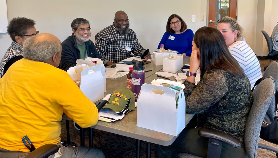 people gathered at a table smiling
