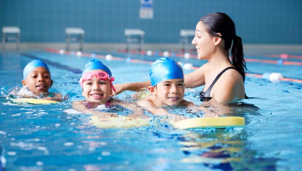 kids learning how to swim in a pool