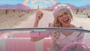 margot robbie stars in Barbie, driving in convertible in scene
