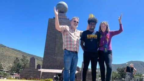 Carlos Wylde-Gladbach and his parents stand on the equator at the Mitad del Mundo complex in Ecuador.