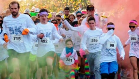 people running the Color 5K through clouds of colorful smoke
