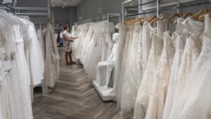 a rack of wedding dresses