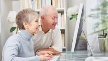 Older people looking at a computer screen.