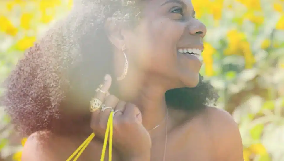 Lia Key smiling and showing off her earrings