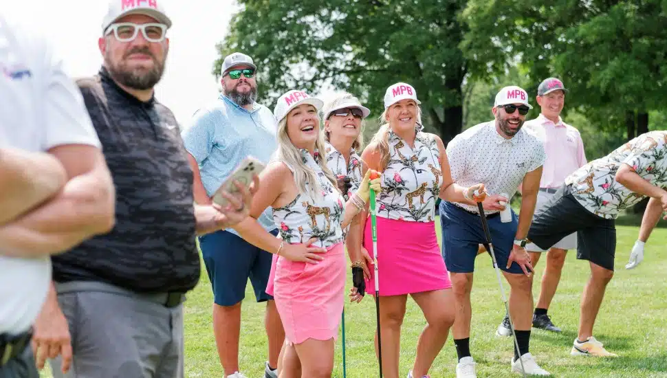 golf players on course wearing pink