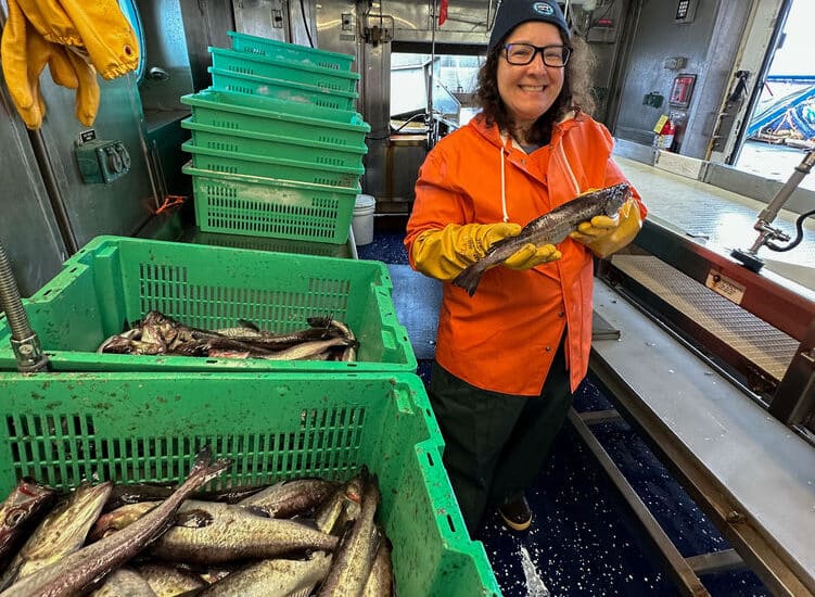 Laura Guertin, distinguished professor of Earth science at Penn State Brandywine, holds a walleye pollock, as part of her time aboard a research ship in the Gulf of Alaska assessing the walleye pollock population.