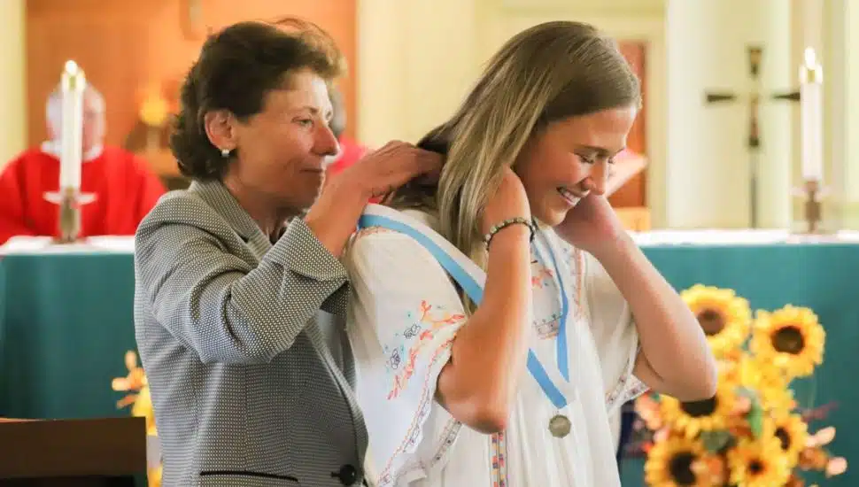 Barbara Lettiere presenting Ava Thorley with her medal.