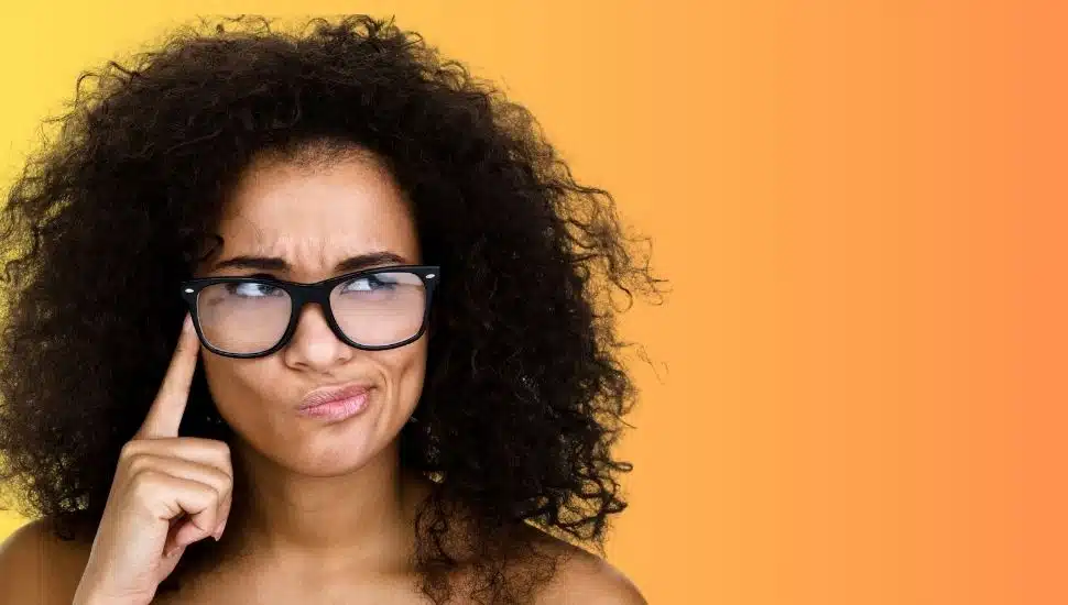 Woman with glasses trying to remember something.