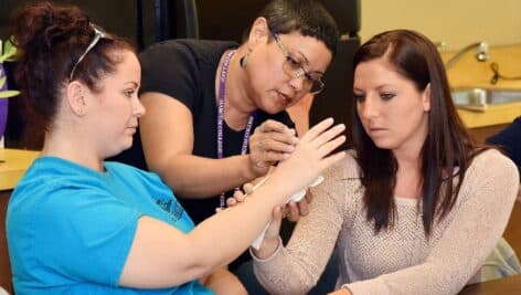 Harcum College Occupational Therapy students immersed in hands-on classroom activity.