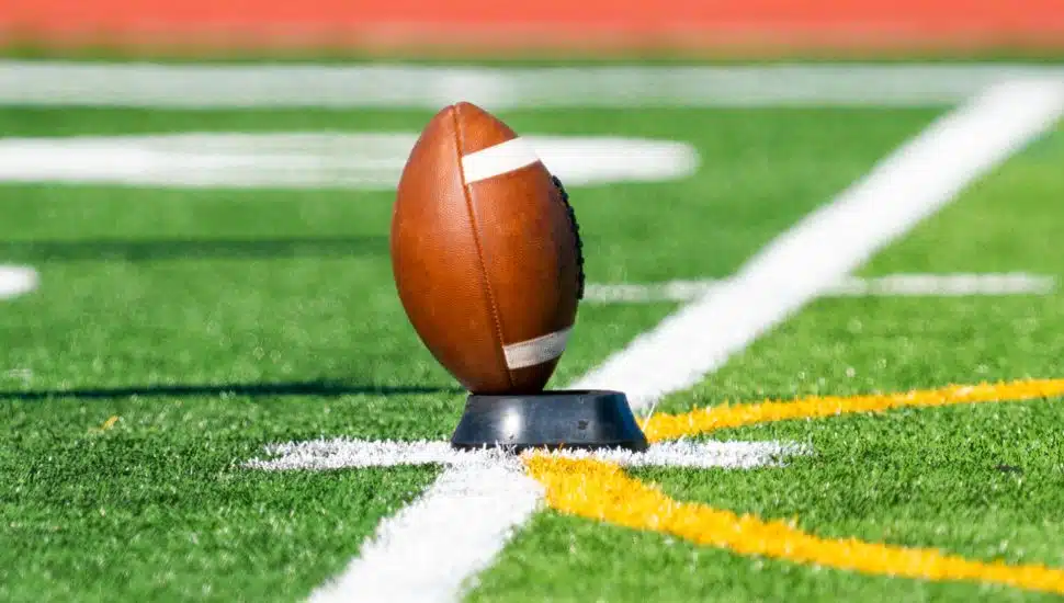 football on tee ready for kickoff
