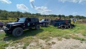 quadratec's 50 for 50 cleanup initiative in coal township jeeps collecting trash outside