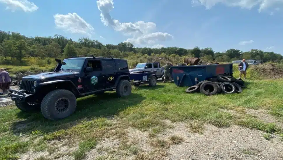 quadratec's 50 for 50 cleanup initiative in coal township jeeps collecting trash outside