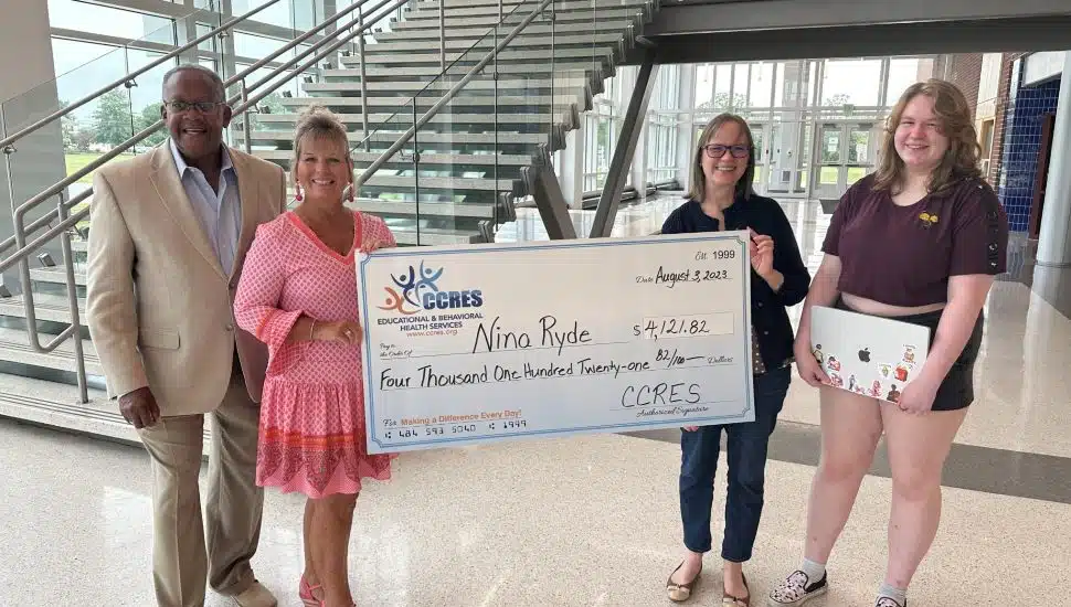 Leon Spencer, CCRES Board Chairman and Sharon King, CCRES, present the CCRES scholarship to Nina and her mom.