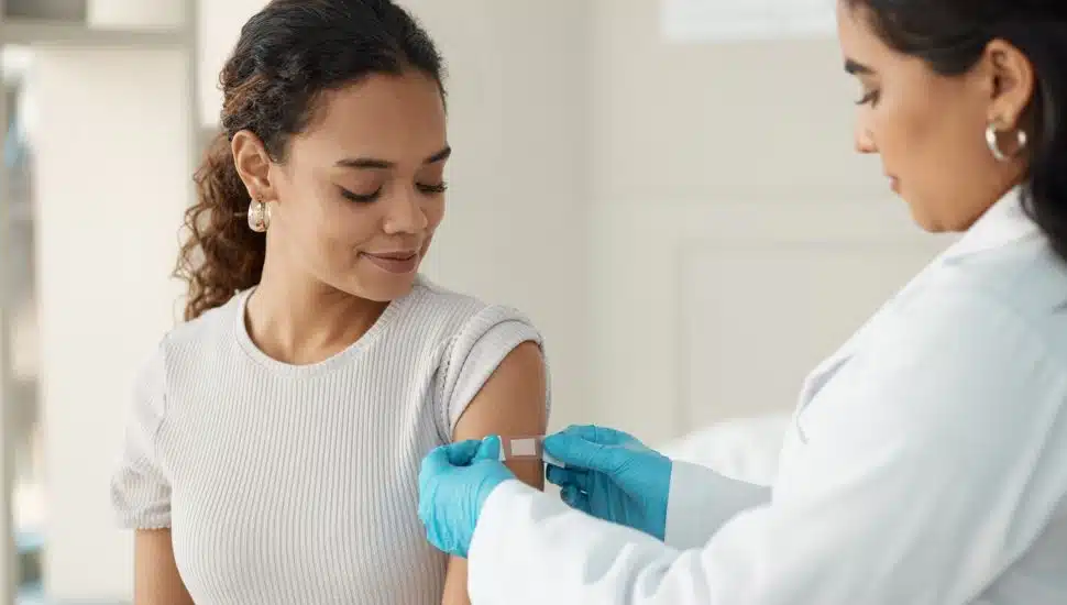 woman receiving bandaid after vaccine